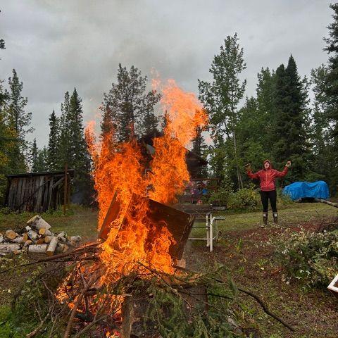 Makenna burning some tree clippings in McCarthy