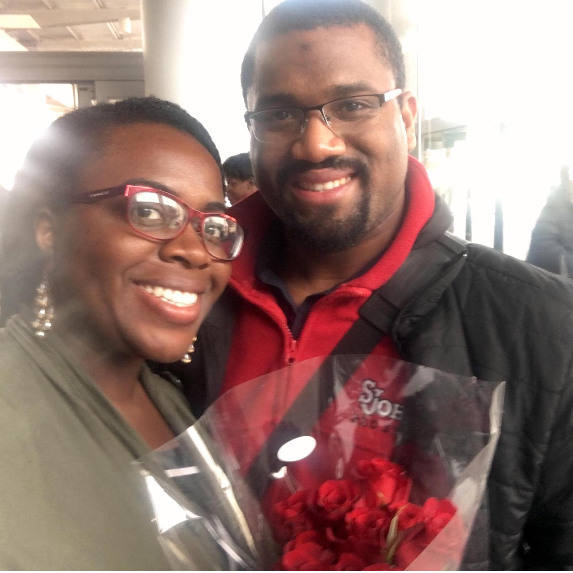 Kevin surprises Martha with flowers at the airport