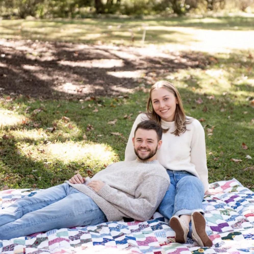 Engagement photo on a quilt that was a gift from Eric's Nana.