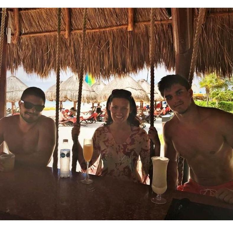 The three amigos hanging at a tiki bar in Cancun, Mexico for a family vacation