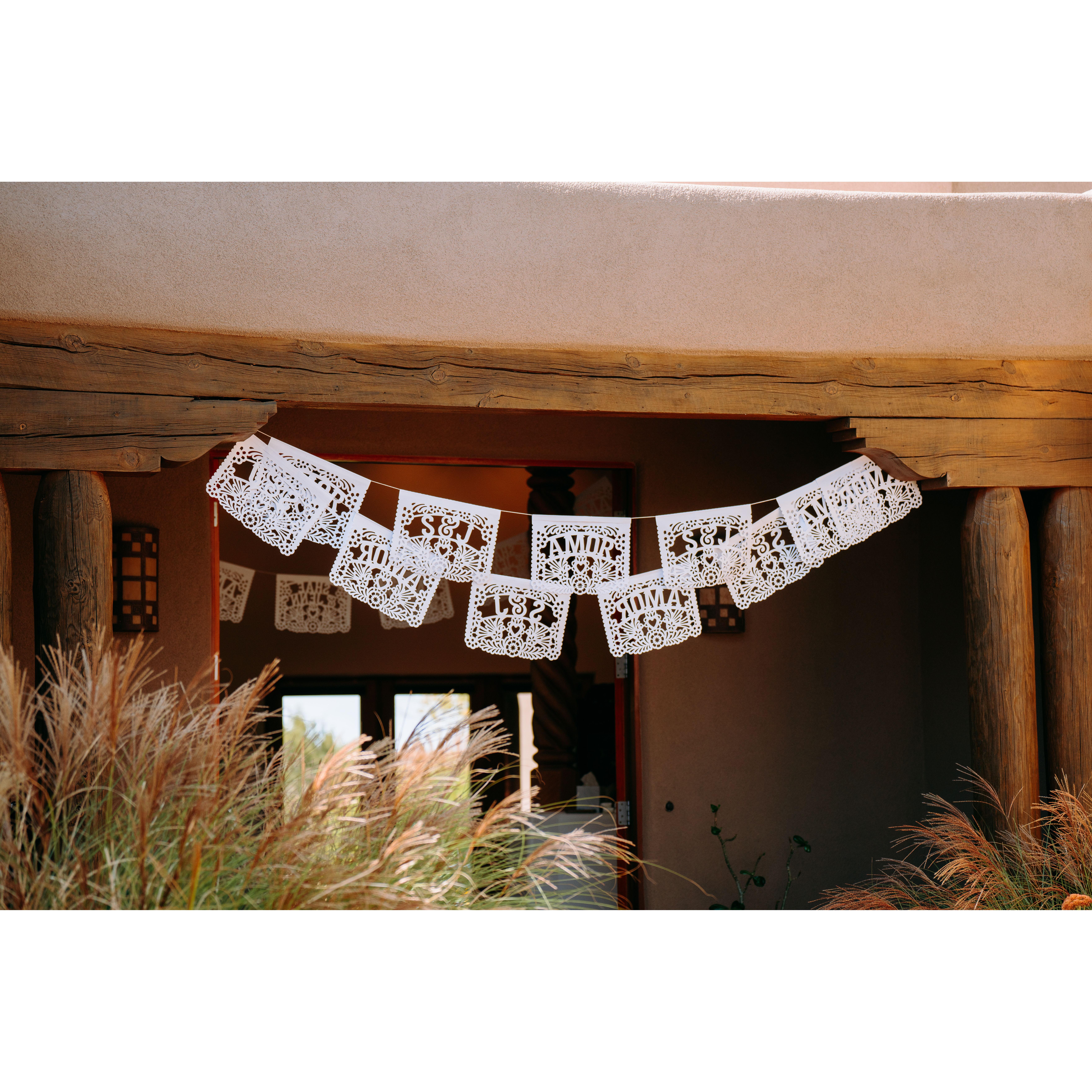 White papel picado flags facing the courtyard
