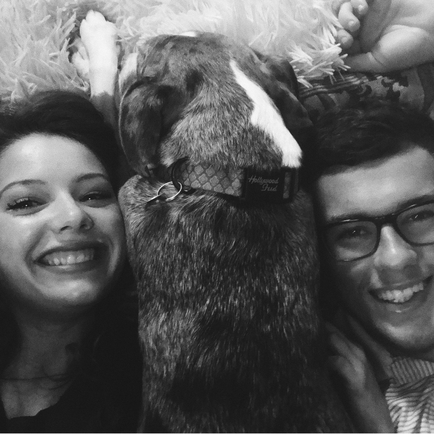 Adam and Marisa hanging out by the fireplace with Grace!