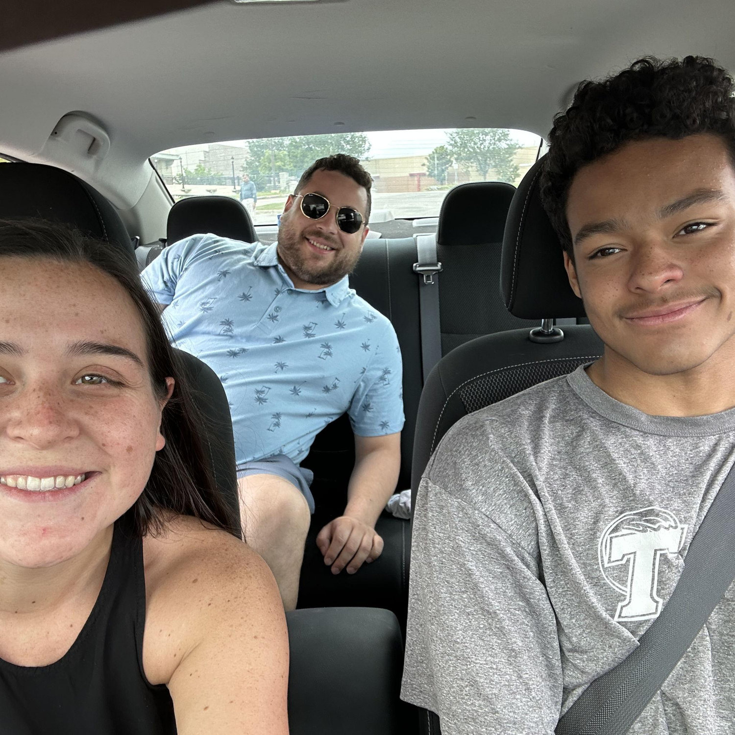 Luke and Joy teaching Frankie how to drive in a parking lot!