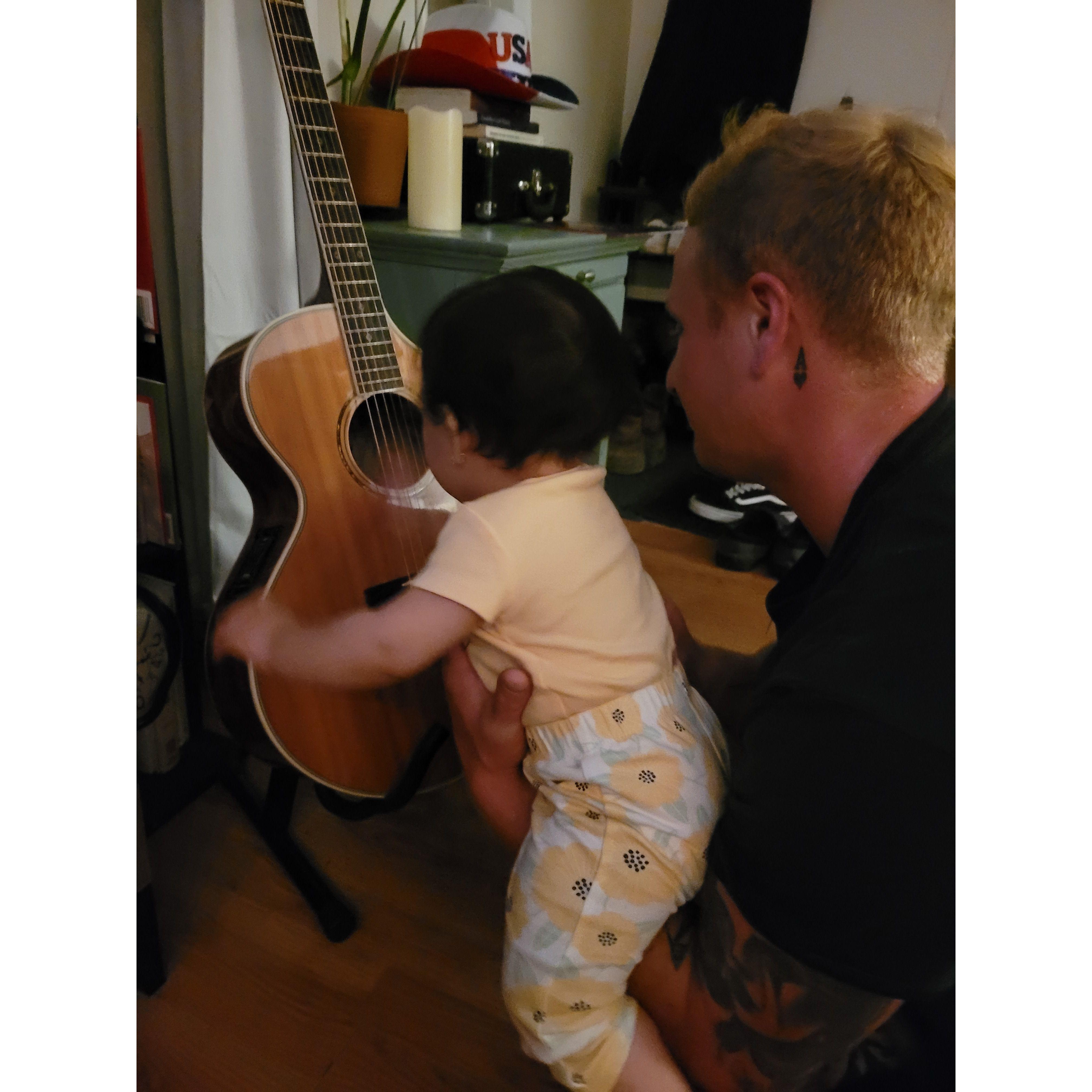 Teaching Sofia how to play guitar