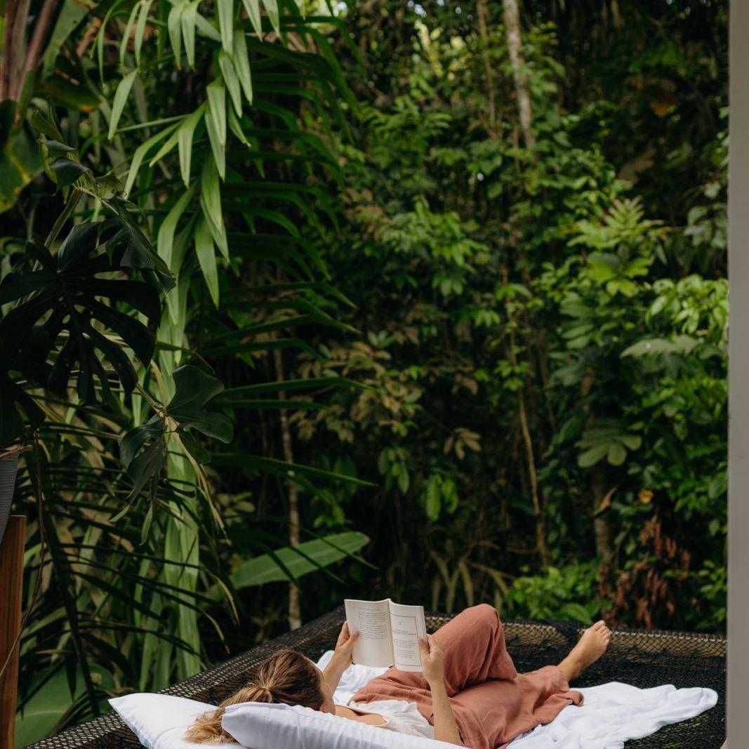 Michaela reading on the deck of one of the cabins at Cinco Cerros