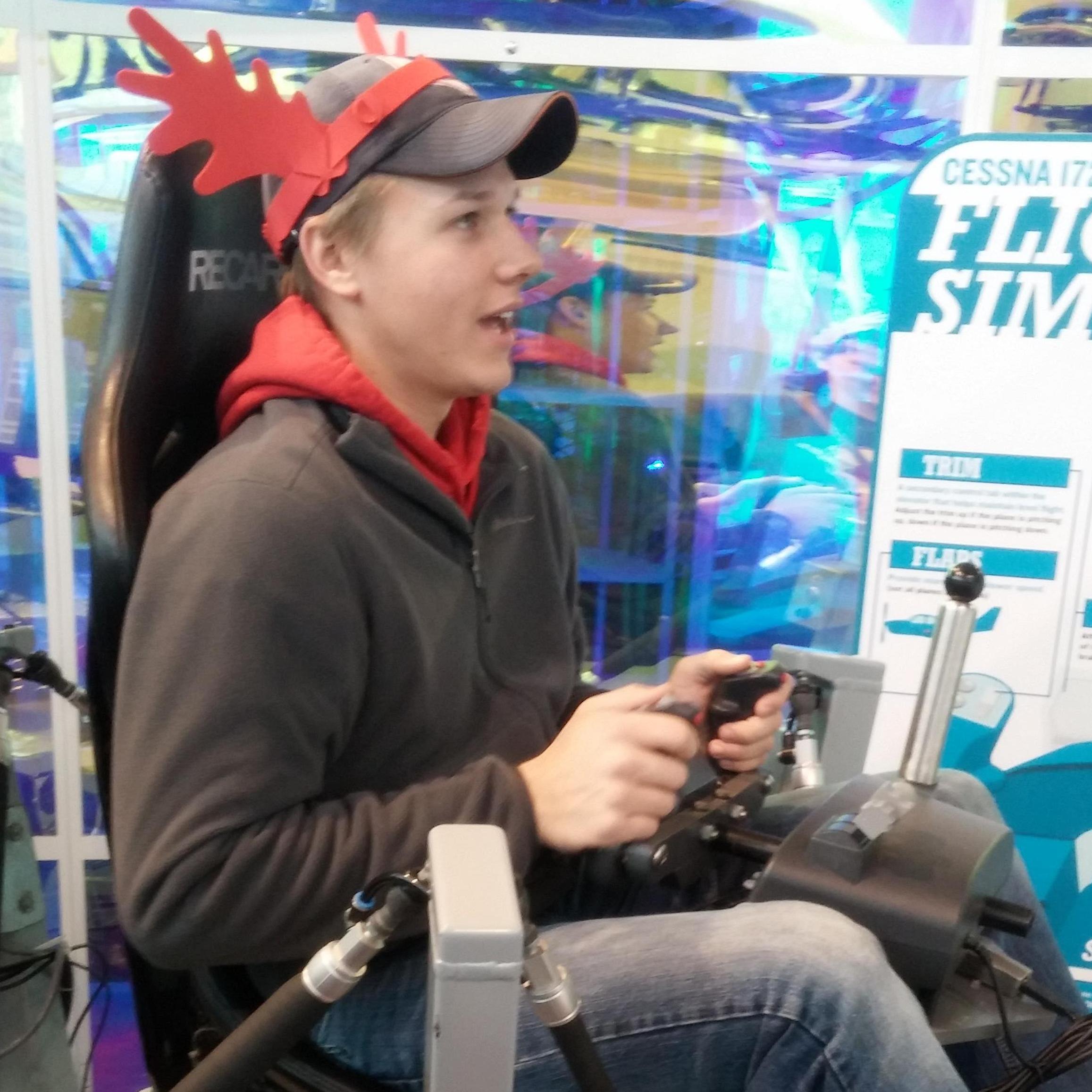 Alex "flying a plane" at Discovery World - notice his fun hat!