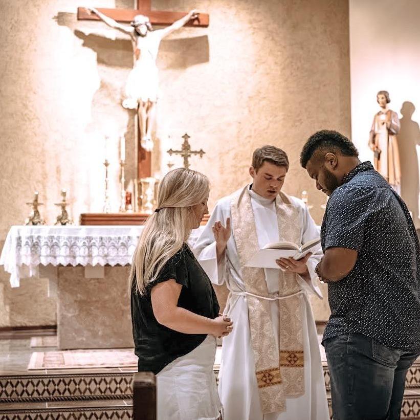 Father Branson blessing our engagement and ring.