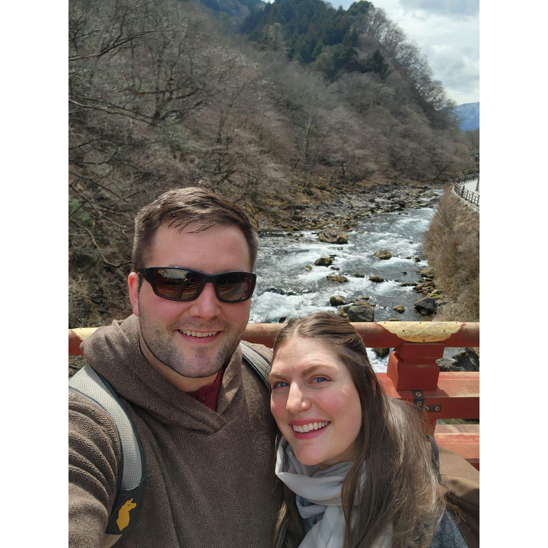 Standing on the Shinkyo Sacred Bridge at the entrance to Nikko’s shrines in Nikko, Japan
