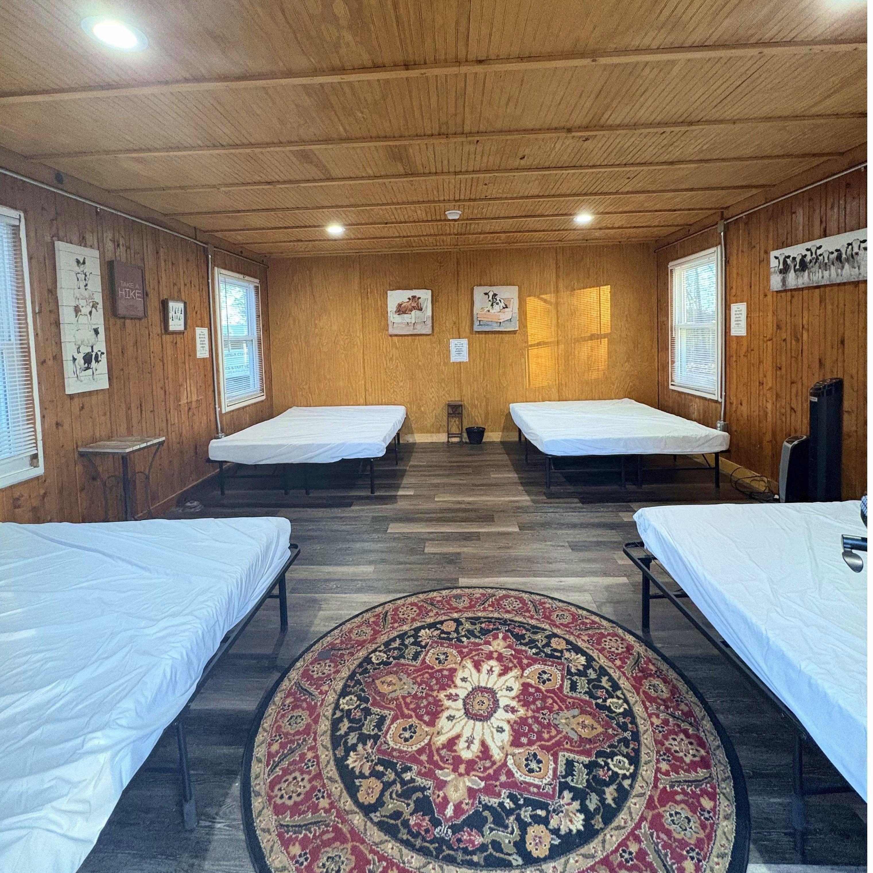 4 Bed Cabin. 4 Queen Size beds. Sleeps 8 Campers. Heating and AC in each cabin.