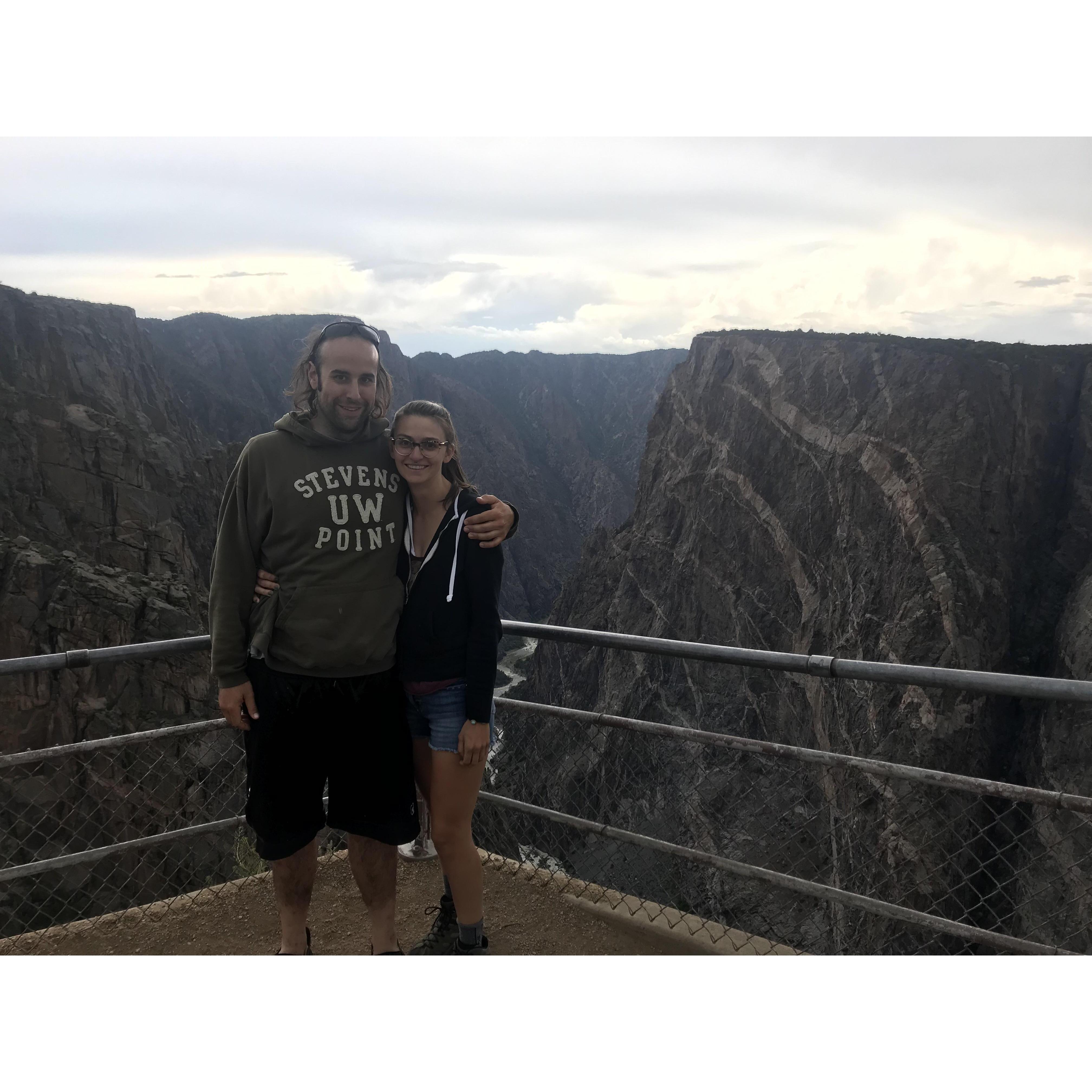 The newly engage couple enjoying the view at Black Canyon National Park, CO. Circa May 2019.