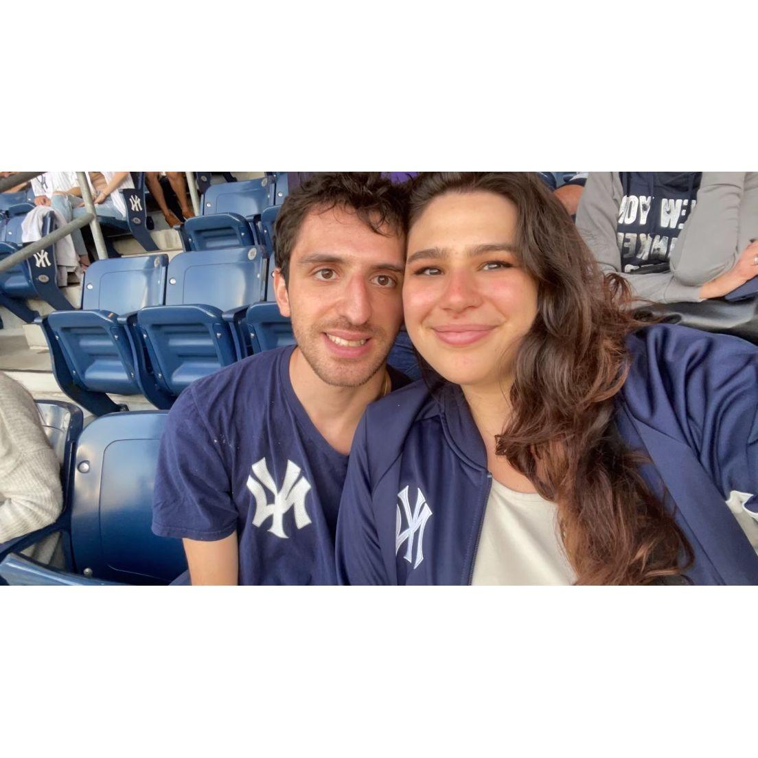 Steve worked to convert Alex to a Yankee fan. She's happy at a game as long as she has a cider.