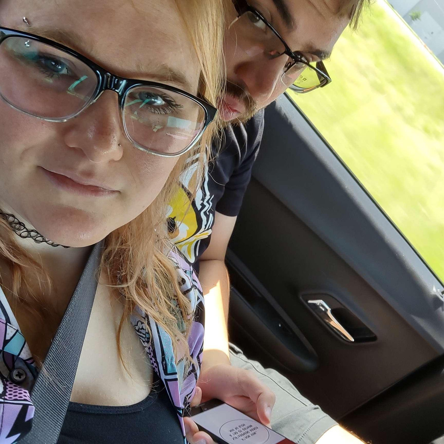 Arliss trying to sneak a picture on the way to Six Flags: Over Texas...