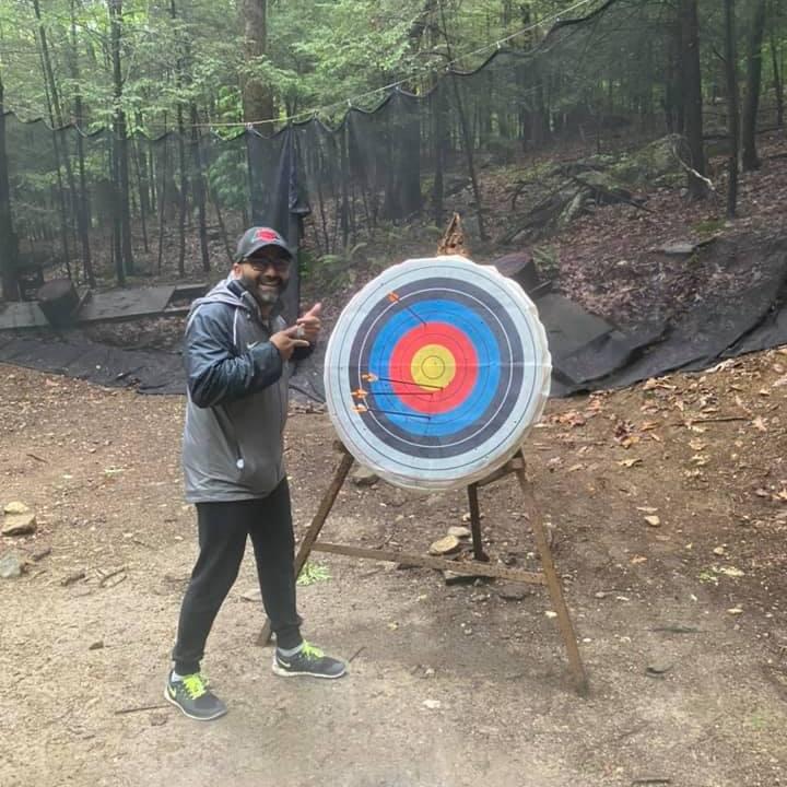 Learning archery on the rainiest of rainy Memorial Day weekends while camping!