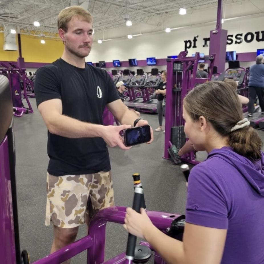 Joshua Holding up my phone so i can watch the Mandalorian while working out