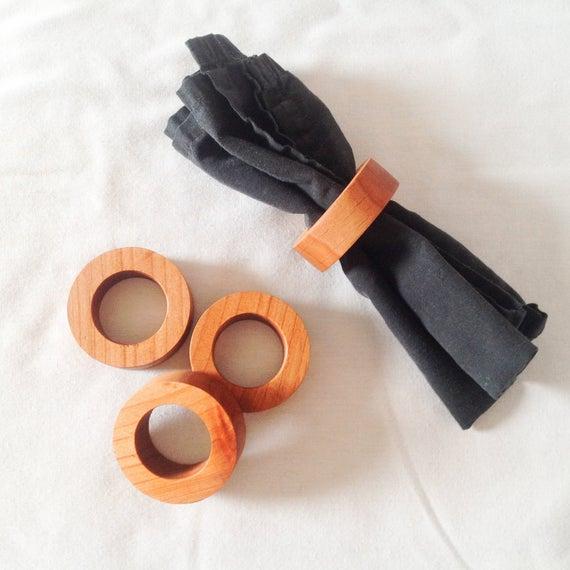 A Set Of 4 Wooden Napkin Rings Handmade with An All Natural Food Grade Finish