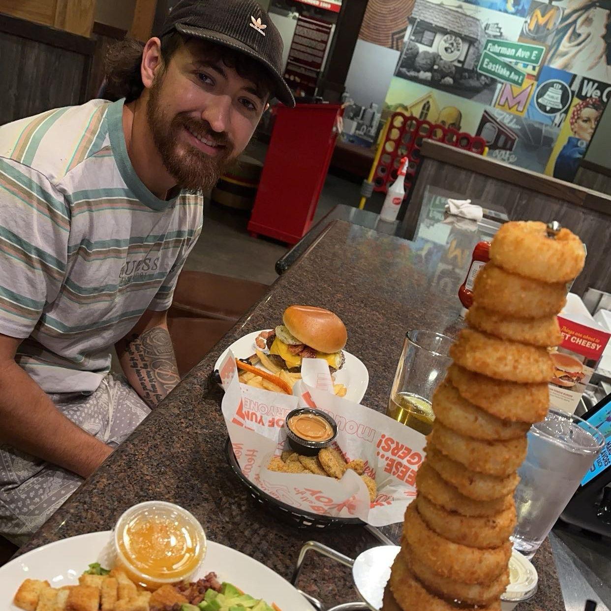 Before this picture, we were scammed in Houston buying a dog. During this picture, I ordered the tower forgetting he hates onions. After this picture, we were on our way home with our dog, Apollo.