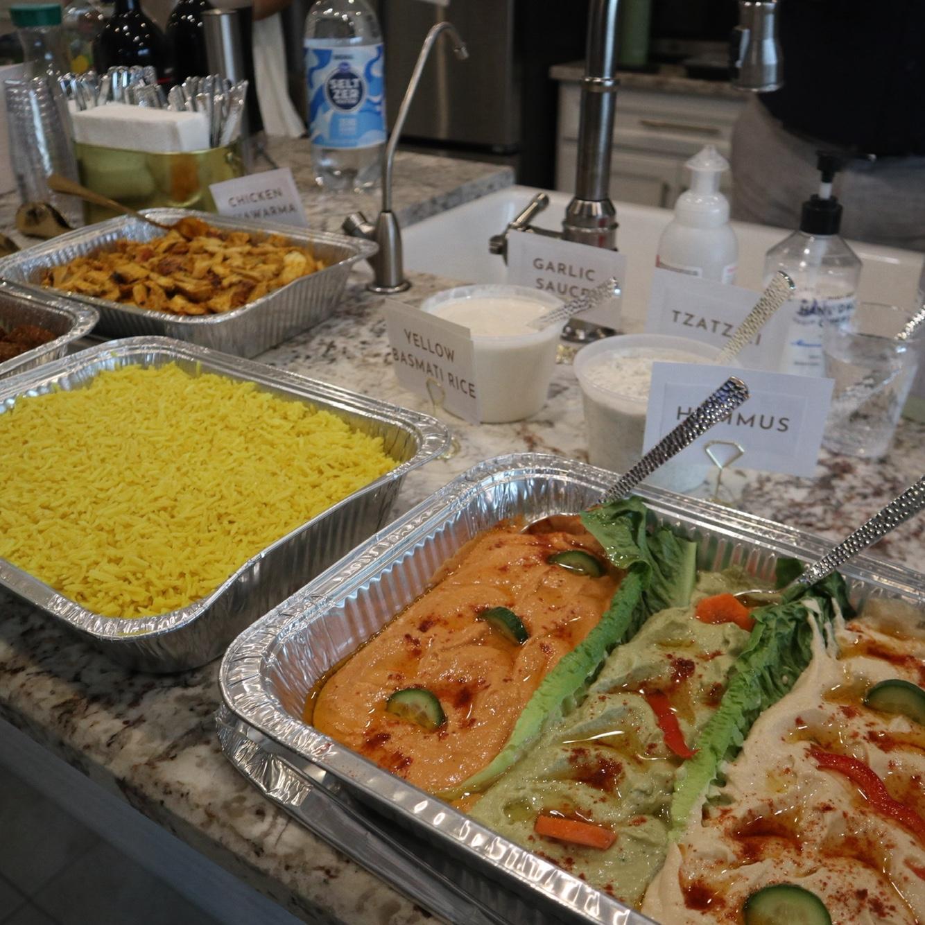 Mediterranean food from a local restaurant (hummus platter, tzatziki, and garlic sauce)
