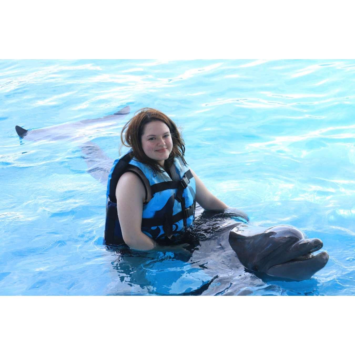 One of the many photos of Elana with a dolphin from our first date!