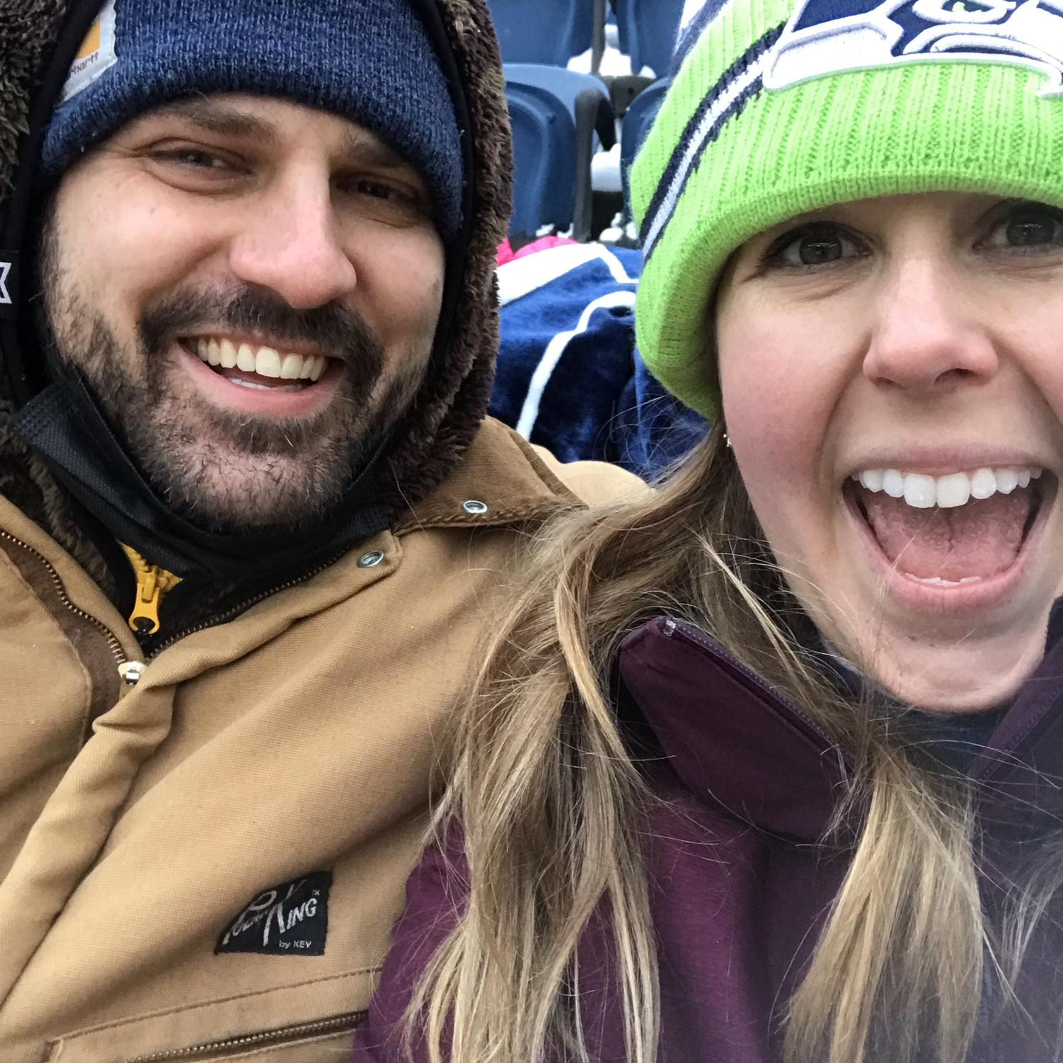 Sitting in the snow at Margaret's first Seahawks game at Lumen. She looks happy but lost all feeling in her fingers #deadhands