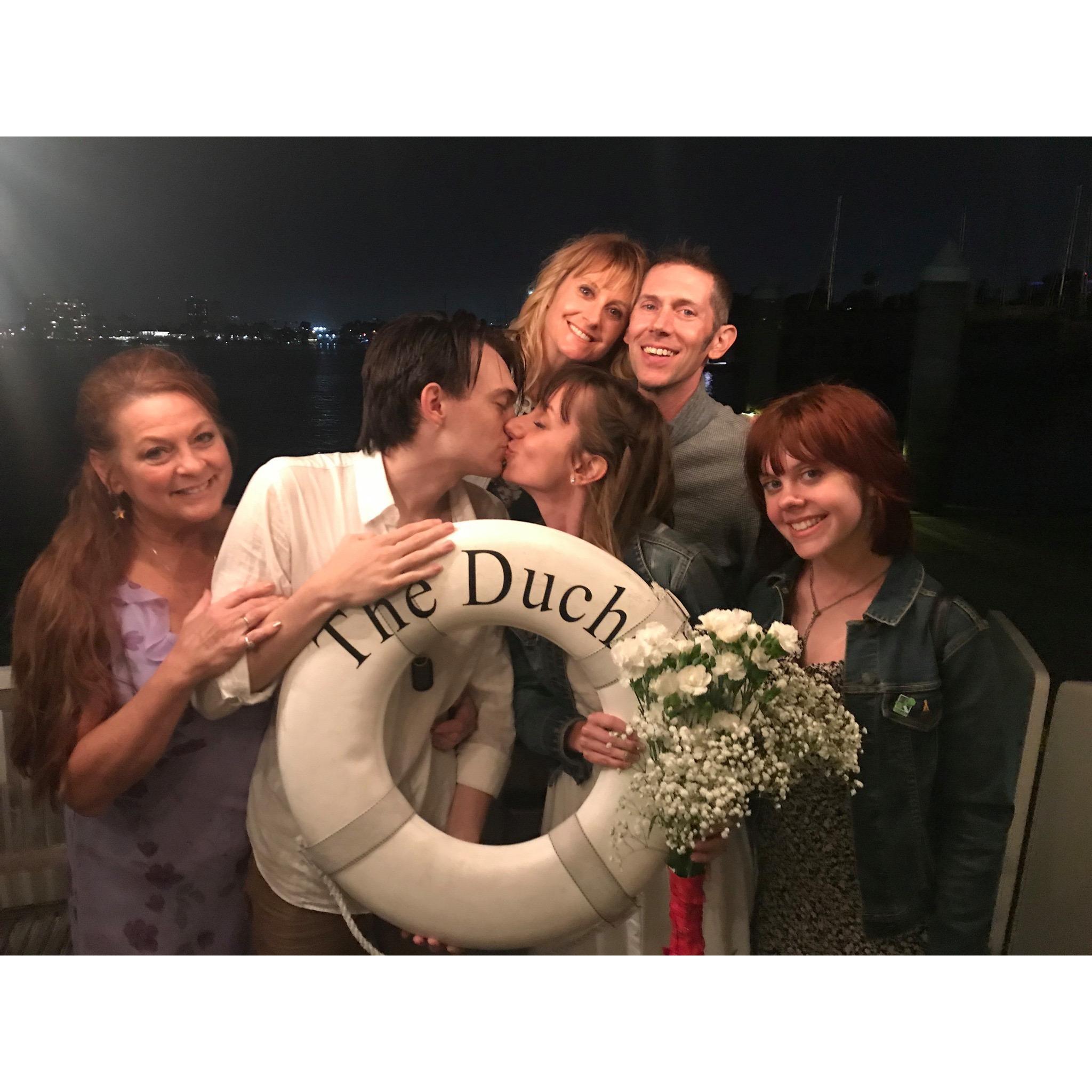 The newlyweds aboard The Duchess with their family, Ashley Snyder, Steve Arm, Anji Arm, and Josie Arm.