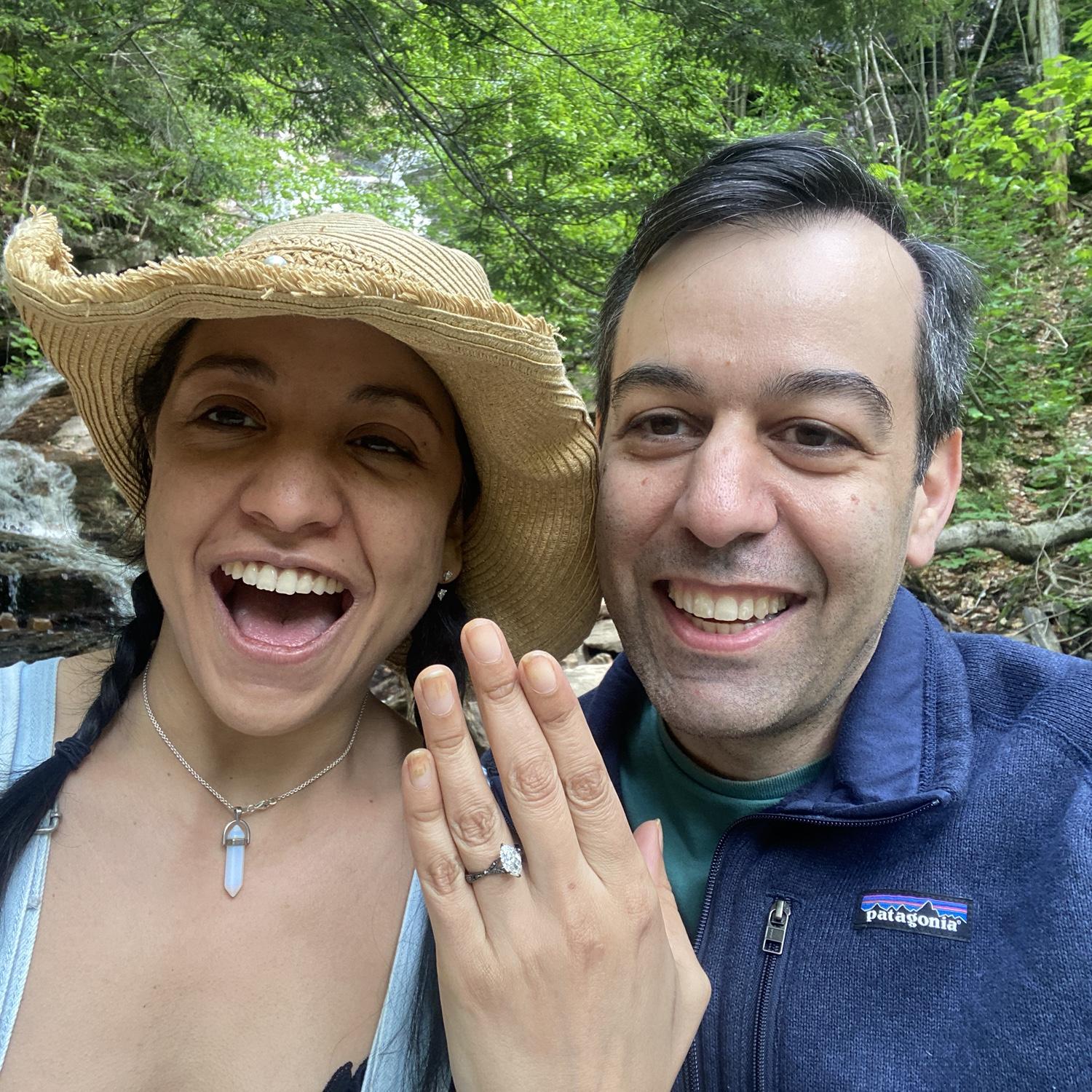 Jason proposed at the end of a very, long, humid hike to the top of a waterfall.  The ring was in his jacket pocket, so he was stuck wearing it all the way up the mountain!