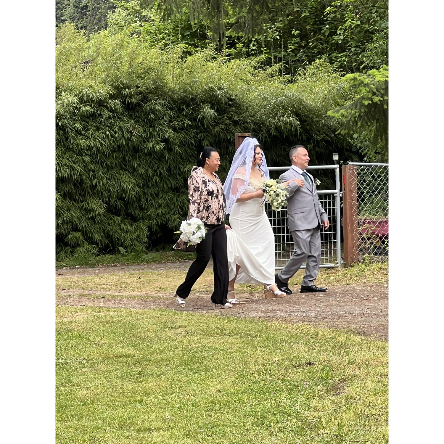 Evelyn and Alex Bran walking Yoselin down the isle.
