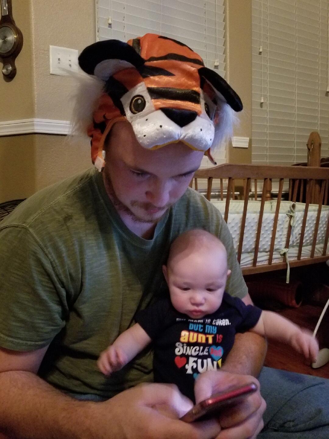 Matthew watching a video with Nathan, wearing a part of Nathan's Halloween costume.