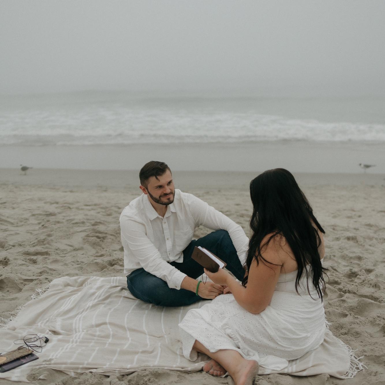 Izabella reading some of her poetry to Konnor by the ocean