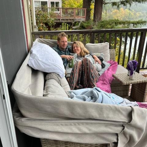 Enjoying reading "Braiding Sweetgrass" together on a deck overlooking the Russian River in Sonoma