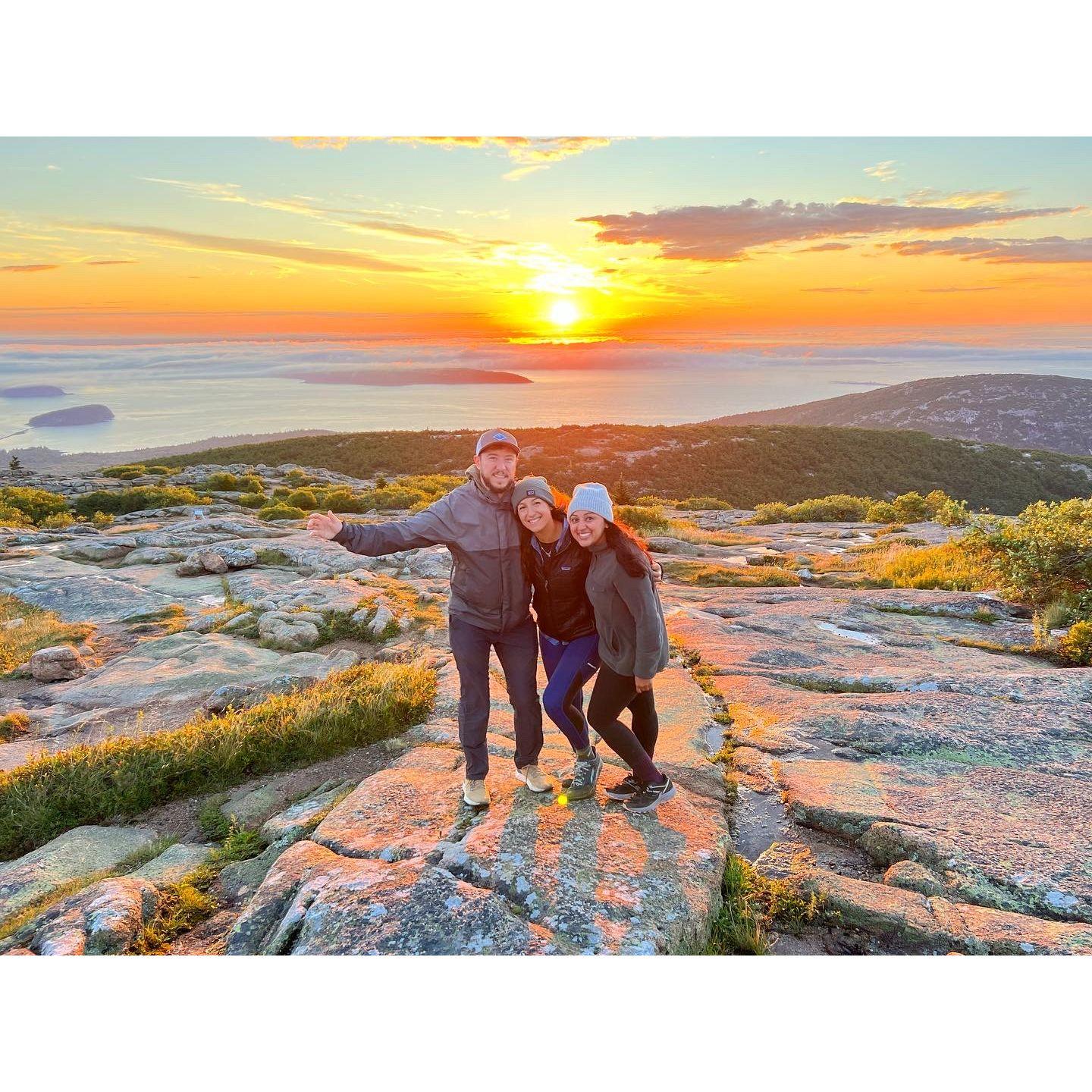 Chris, Apoorva, and Chanel greet the sunrise on Cadillac Mountain
